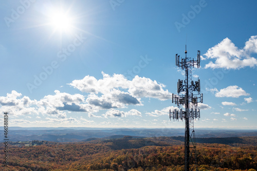 Aerial view of mobile phone cell tower over forested rural area of West Virginia to illustrate lack of broadband internet service photo