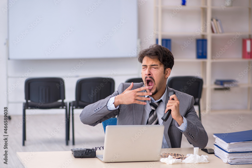 Young businessman employee suffering at workplace