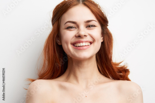 cheerful woman with bare shoulders hairstyle fashion glamor