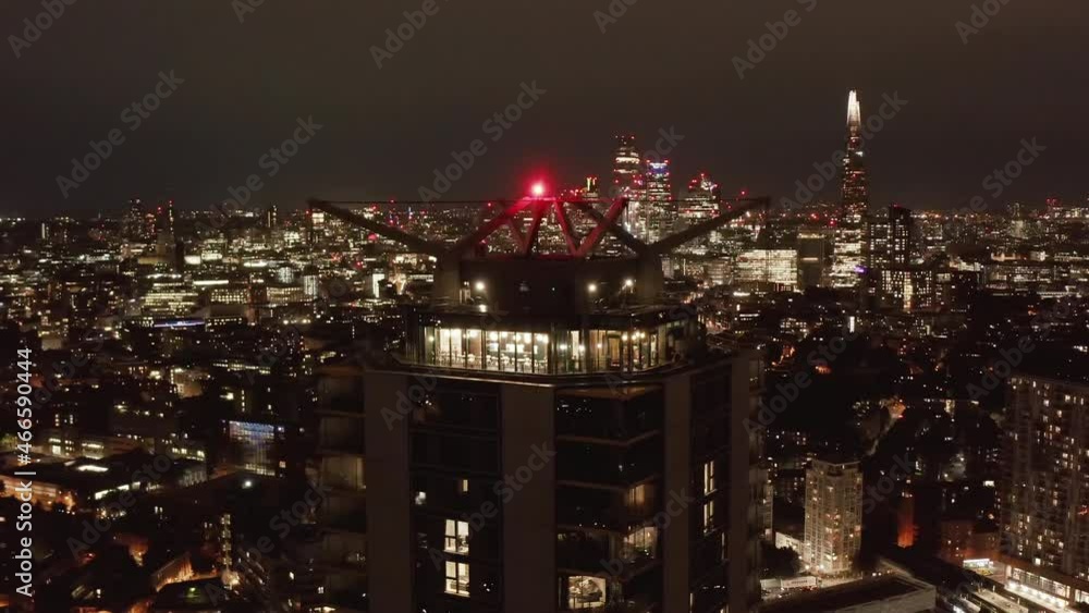 Fly around roof lookout terrace at tall apartment building. Night scene with city panorama. London, UK Fly around roof lookout terrace at tall apartment building. Night scene with city panorama. London, UK