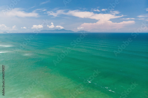 Aerial view of beautiful vietnamese landscape, emerald South China Sea near Hoi An and blue cloudy sky, Vietnam