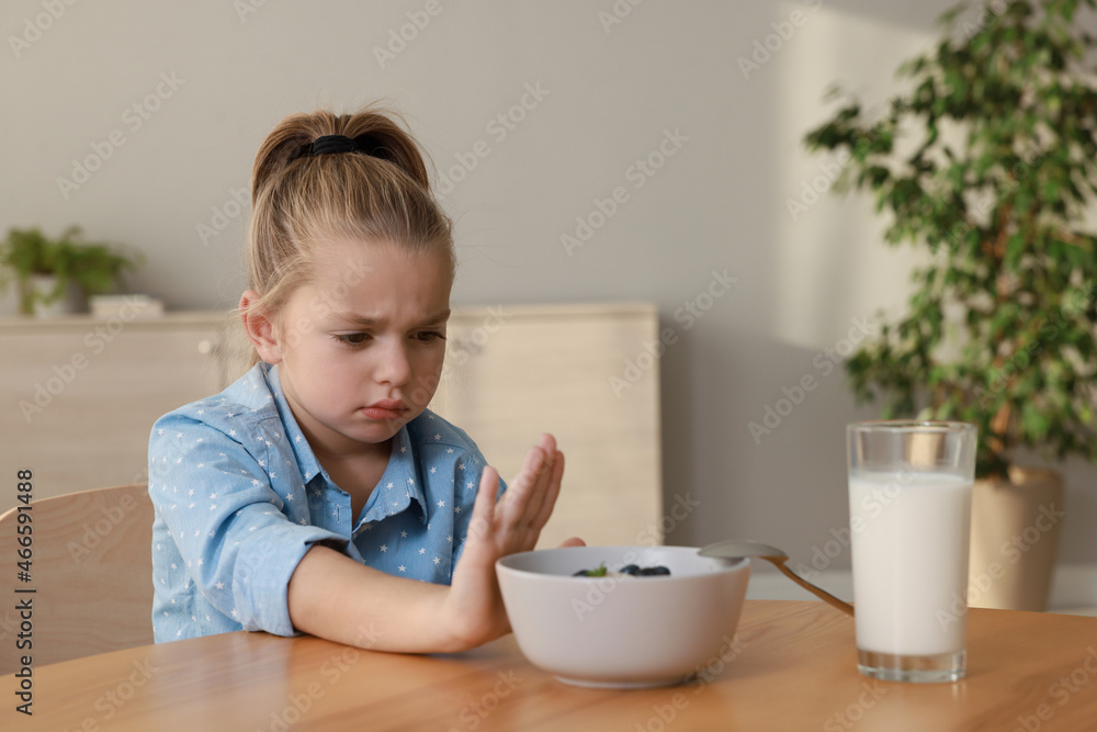 Cute little girl refusing to eat her breakfast at home Cute little girl refusing to eat her breakfast at home