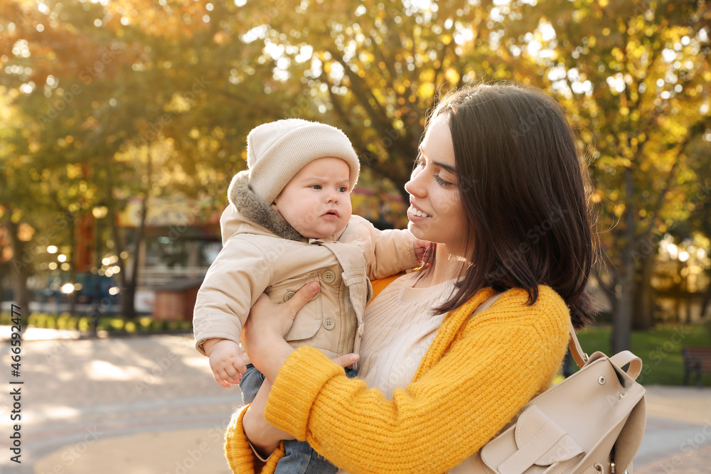 Happy mother with her baby son outdoors on autumn day Happy mother with her baby son outdoors on autumn day