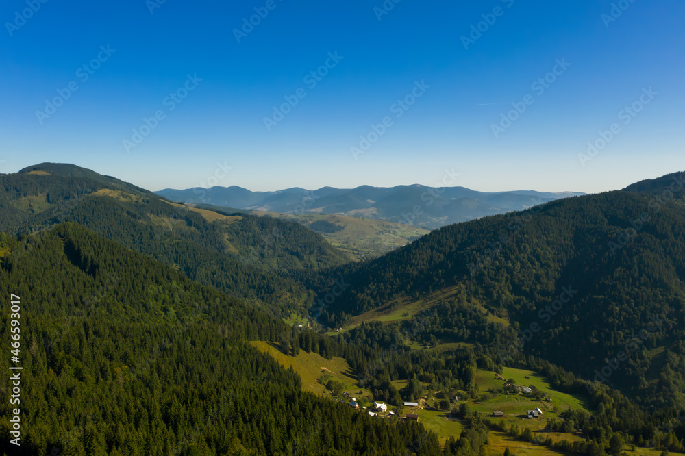 Beautiful landscape with forest and village in mountains. Drone photography