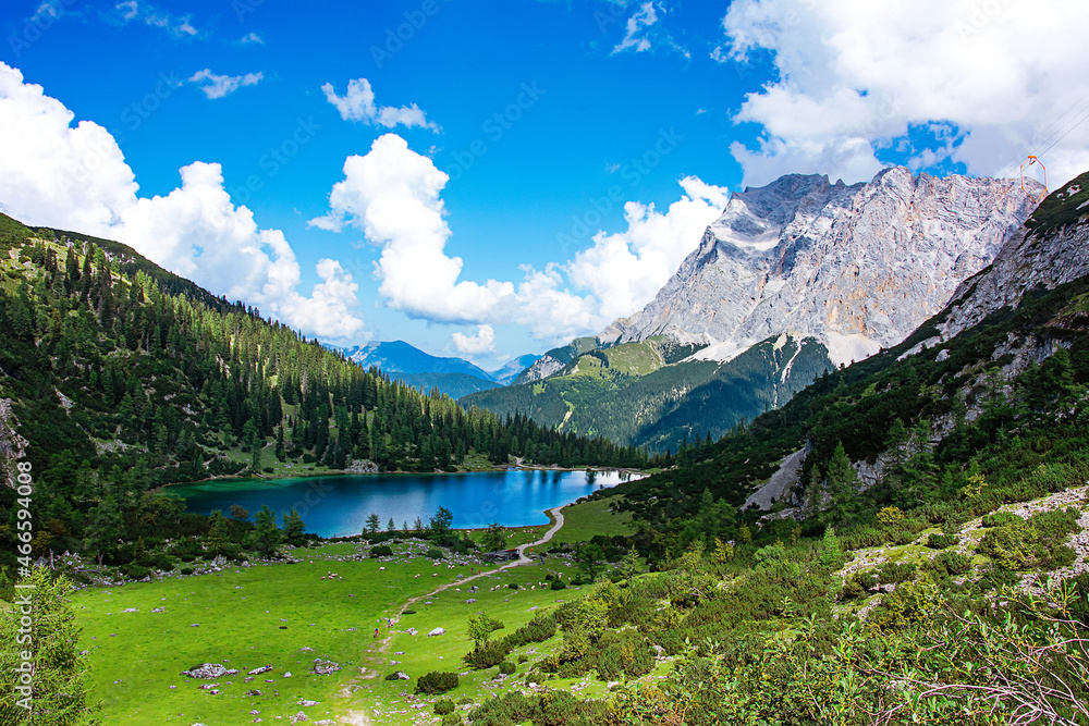 The Seebensee in Austria in Tyrol in the valley between two rock faces with a view of the Zugspitze.