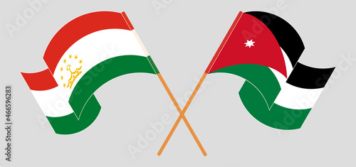Crossed and waving flags of Tajikistan and Jordan