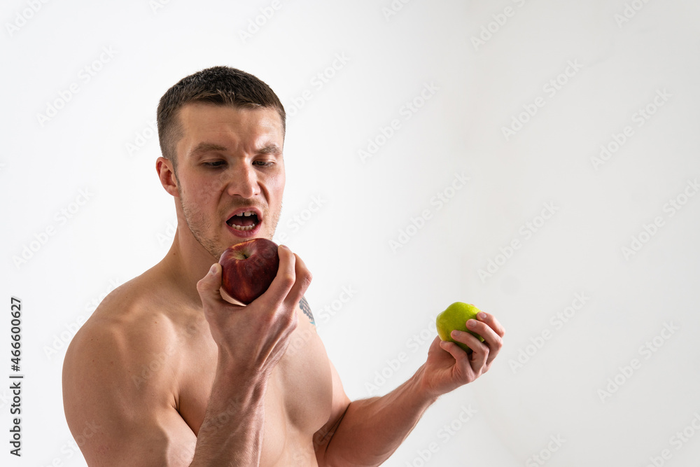 Man holds apples in fitness white background isolated healthy man fruit sport shirtless, nude. wellness chest Man holds apples in fitness white background isolated healthy man fruit sport shirtless, nude. wellness chest