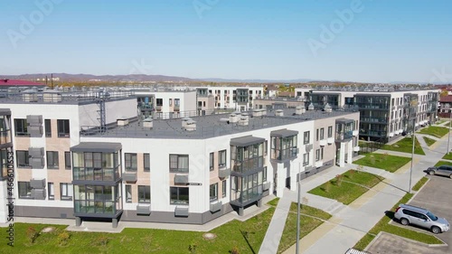 The camera zooms in and out over the rooftops of new residential buildings. New world district in the suburbs of Vladivostok. View from above.