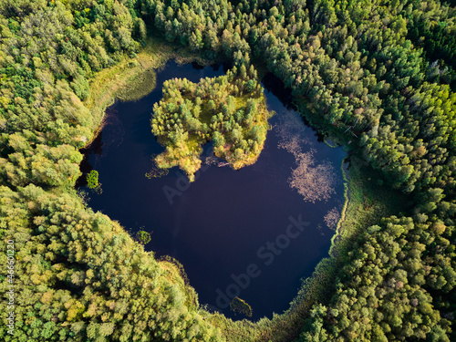 A view from a great height to a beautiful lake in the middle of a green forest, a lake on the site of the former peat mining