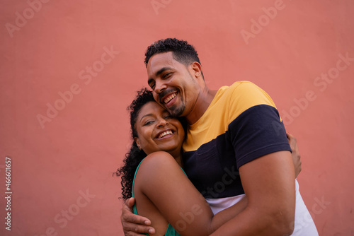 Afro Latin couple loving each other with colored background