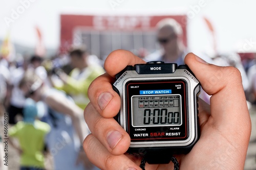 Classic metallic chrome mechanical analog stopwatch in a hand