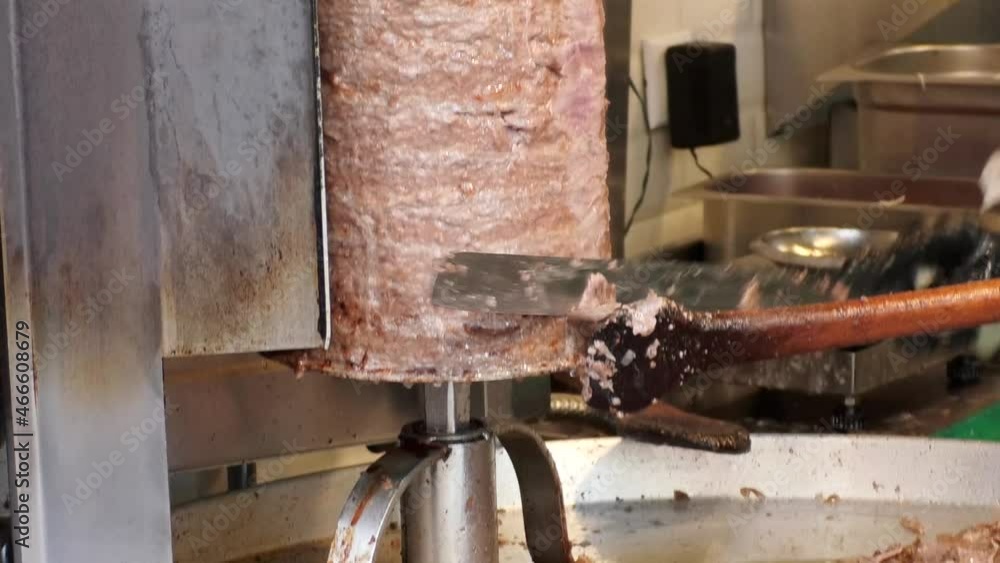traditional turkish kebab doner kebab. The chef cuts the doner kebab. meat doner kebab close up. traditional turkish kebab doner kebab. The chef cuts the doner kebab. meat doner kebab close up.