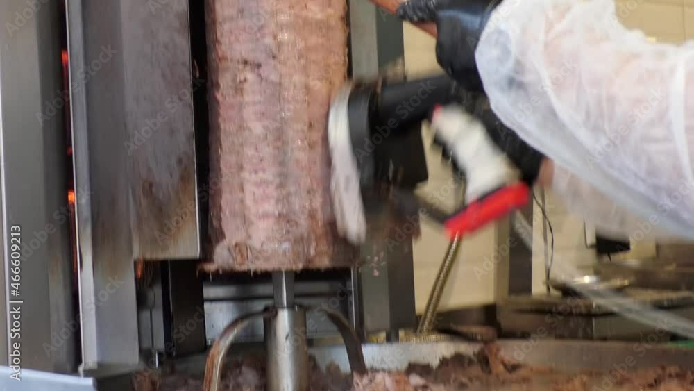 traditional turkish kebab doner kebab. The chef cuts the doner kebab. meat doner kebab close up. traditional turkish kebab doner kebab. The chef cuts the doner kebab. meat doner kebab close up.