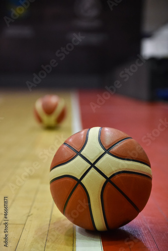 Basketball on Court Floor close up with blurred second ball and background