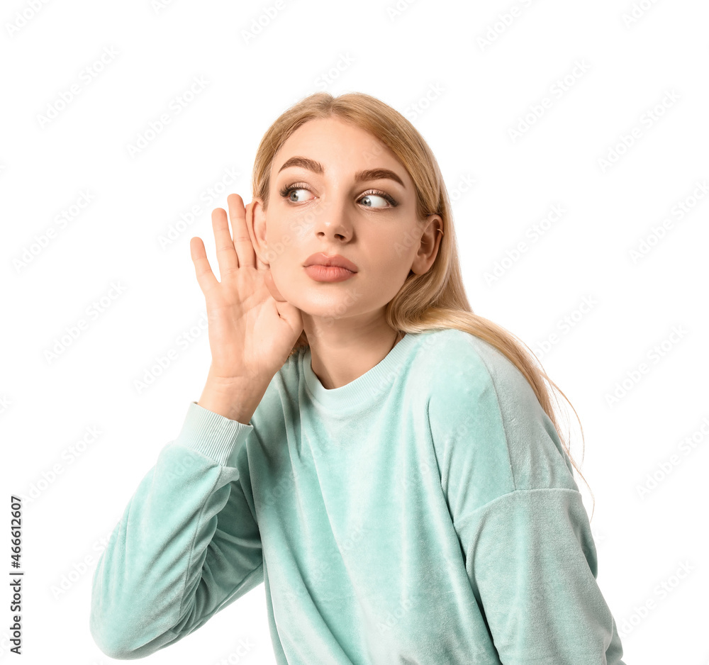 Young woman trying to hear something on white background Young woman trying to hear something on white background