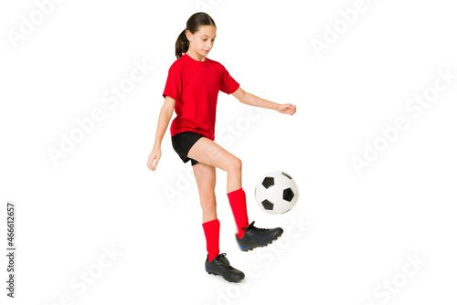 Fototapeta Naklejka Na Ścianę i Meble -  Skilled young girl doing a soccer trick