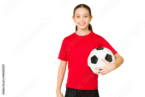 Sporty preteen paying soccer