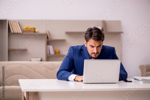 Young businessman working from house