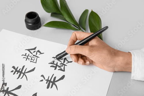 Asian calligraphist writing...