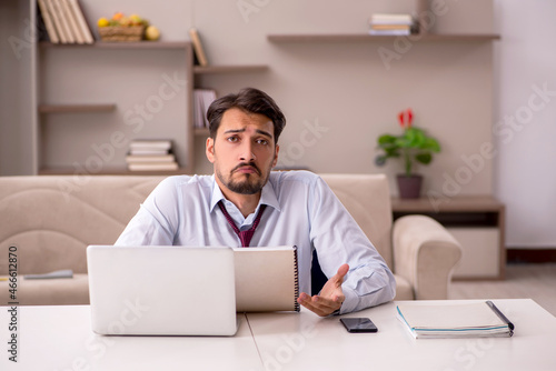 Young businessman working from house