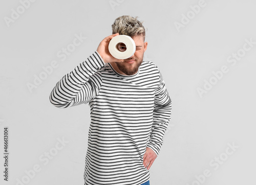 Young man with toilet paper...