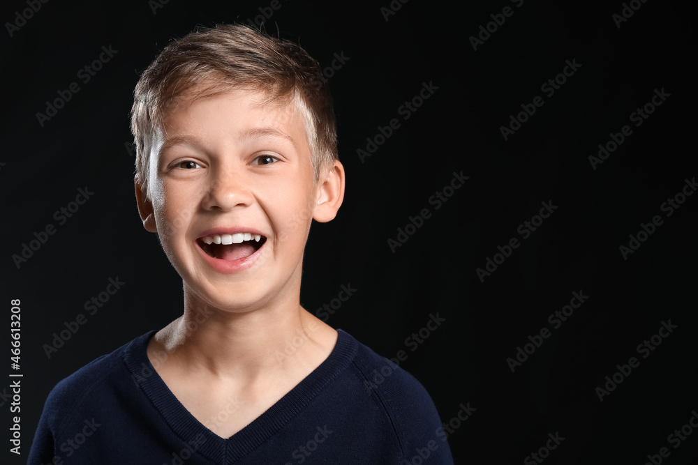 Portrait of happy little boy on black background Portrait of happy little boy on black background