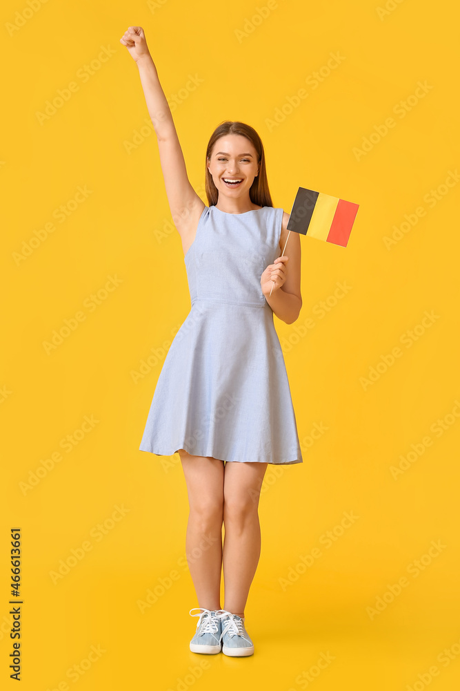 Happy young woman with flag of Belgium on color background Happy young woman with flag of Belgium on color background