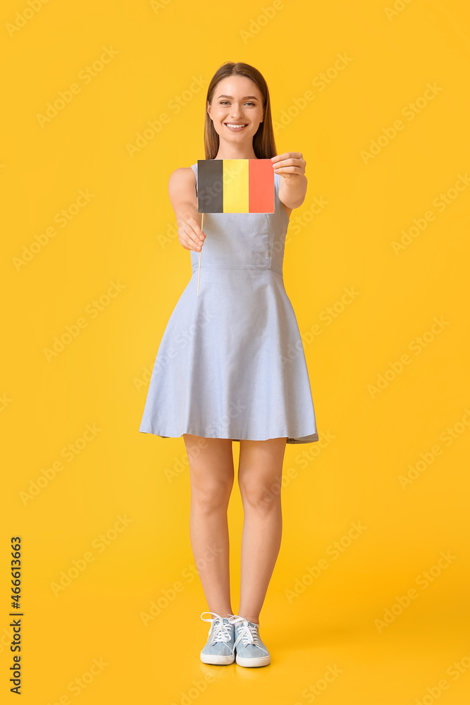Young woman with flag of Belgium on color background Young woman with flag of Belgium on color background
