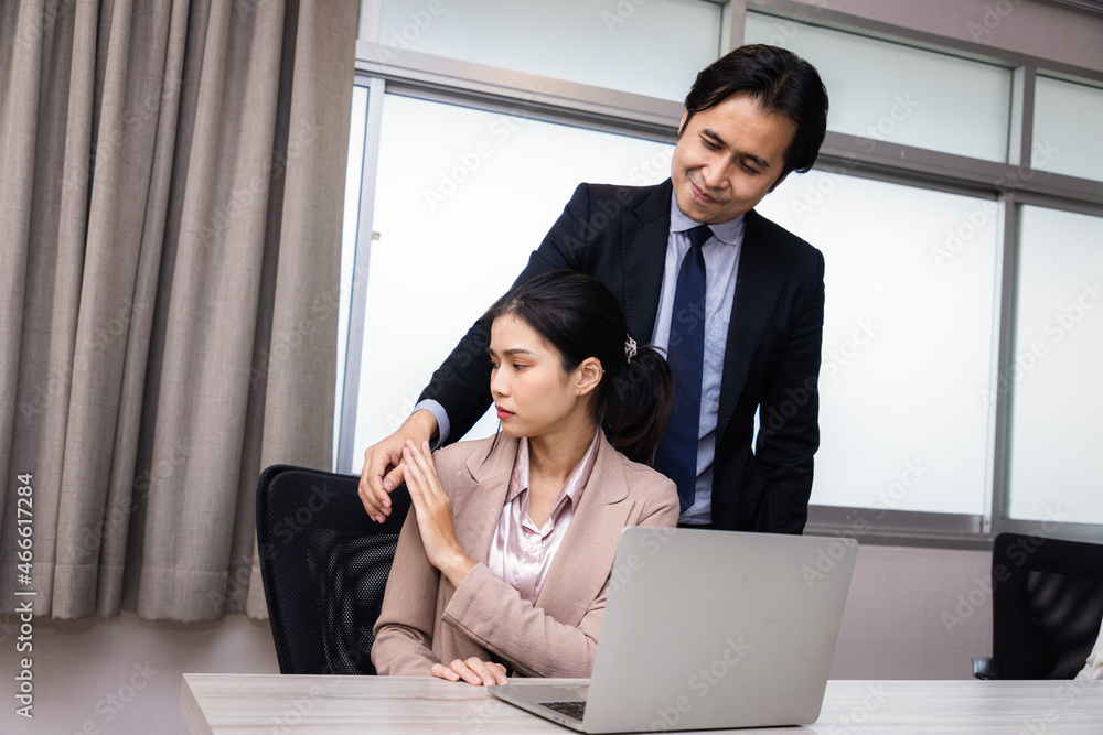 A Boss touching the shoulder of employee colleague in workplace at office. A Boss touching the shoulder of employee colleague in workplace at office.