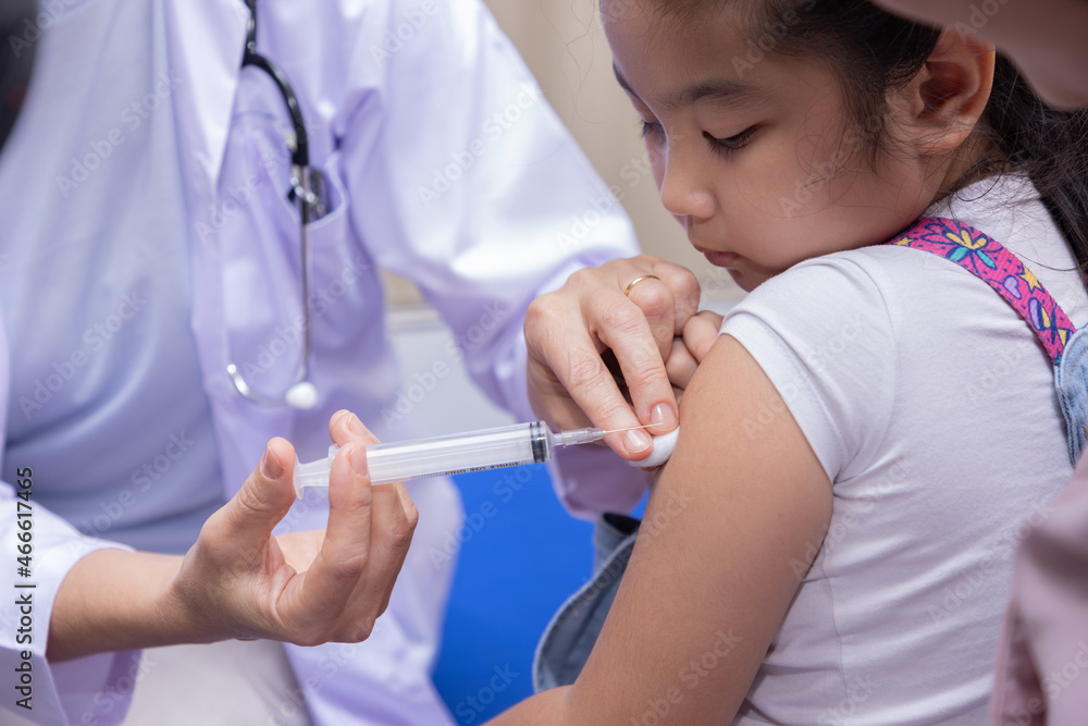 Close-up of Pediatrician doctor doing vaccination of a little girl. Close-up of Pediatrician doctor doing vaccination of a little girl.