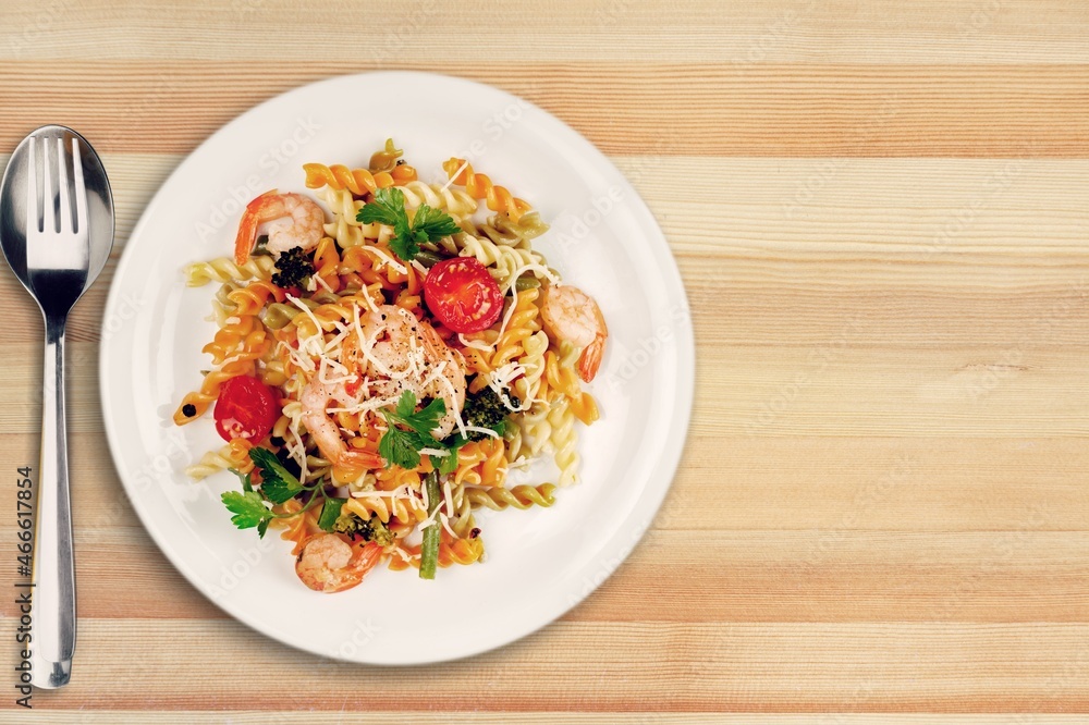Pasta with cherry tomatoes, cheese and basil on a light plate Pasta with cherry tomatoes, cheese and basil on a light plate