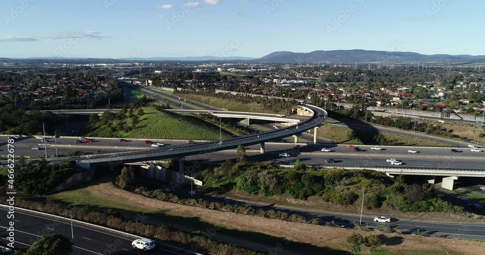 Slow drone tracking and sliding around major highway interchange above suburb sprawl below. Slow drone tracking and sliding around major highway interchange above suburb sprawl below.