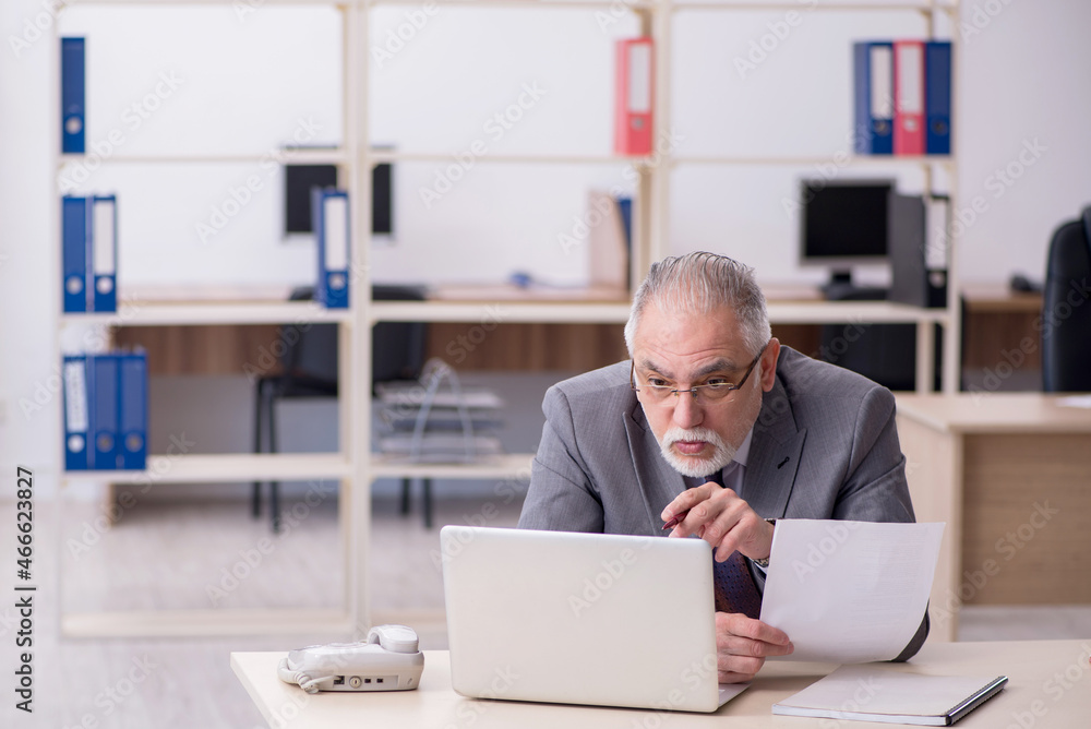 Old male employee and too much work in the office Old male employee and too much work in the office