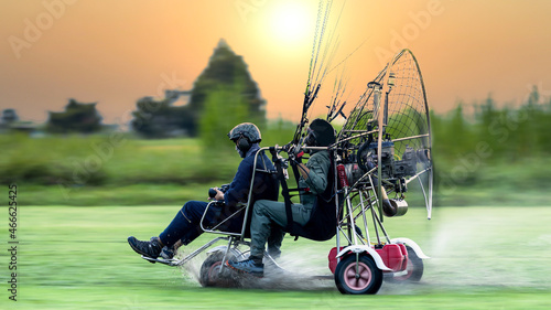 Two men flying and gliding in the air, Flying on paramotor, Preparation for flights on paramotors, Tandem paramotorgliding. photo