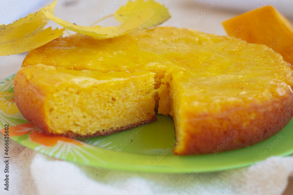 Pumpkin pie made of yellow sweet pumpkin baked in autumn and decorated with yellow leaves Pumpkin pie made of yellow sweet pumpkin baked in autumn and decorated with yellow leaves