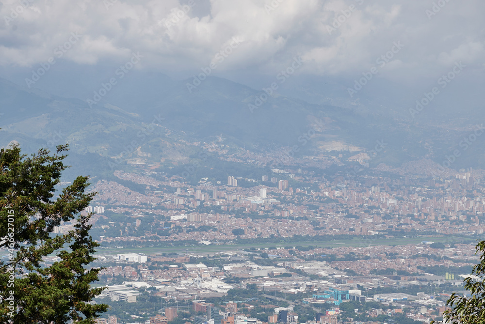 afternoon in the city of medellin from the viewpoint cloudy sky you can see the airport area