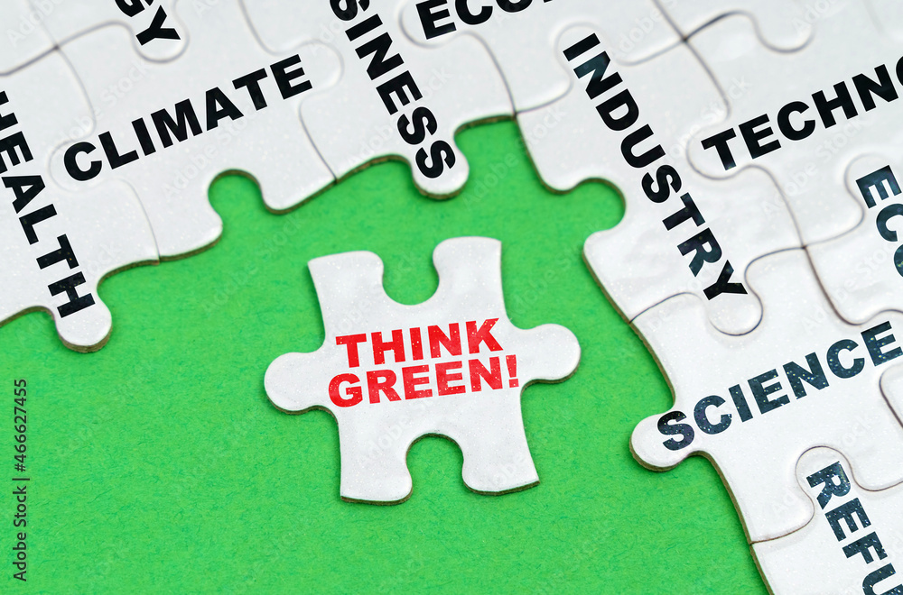 On a green background, white puzzles with text, a puzzle with the inscription - Think Green On a green background, white puzzles with text, a puzzle with the inscription - Think Green