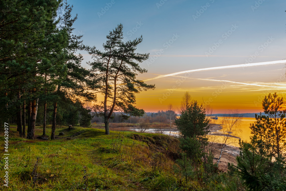 A beautiful view of the river from the high bank with pines and birches. Landscape. A beautiful view of the river from the high bank with pines and birches. Landscape.