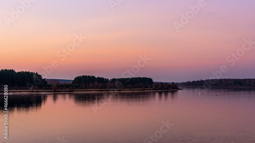 A beautiful view of the river from the high bank during sunset. Autumn landscape. © Andrey Nikitin