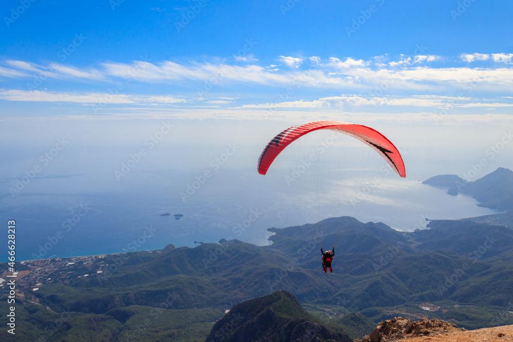 Fototapeta premium Paragliders flying from a top of Tahtali mountain near Kemer, Antalya Province in Turkey. Concept of active lifestyle and extreme sport adventure