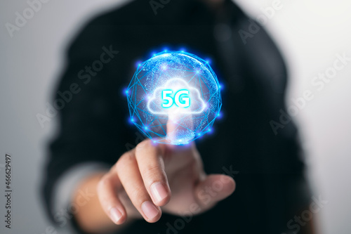 Businessman connects data information on a wireless internet network using 5G technology, social media, and digital e-commerce through a cloud computing network.