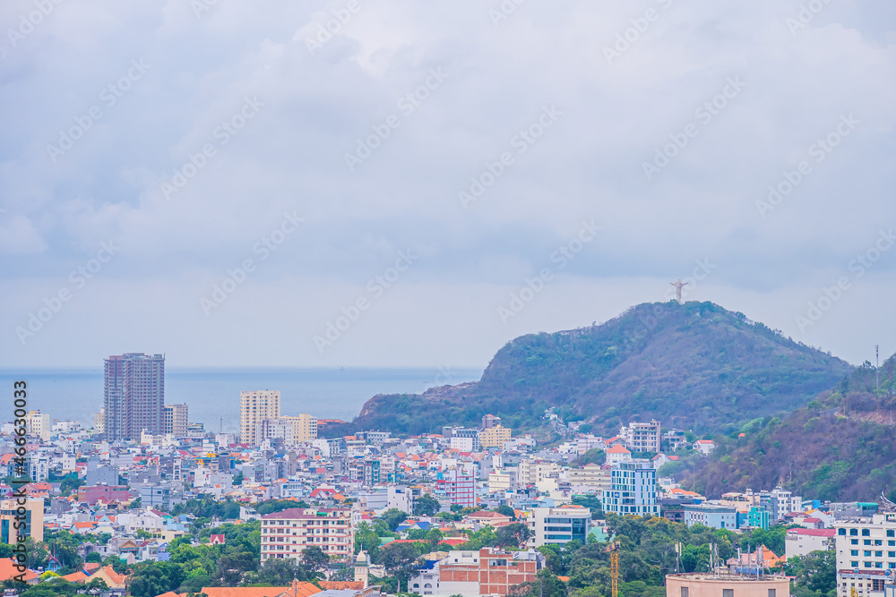 Panoramic coastal Vung Tau view from above, with waves, coastline, streets, coconut trees and Tao Phung mountain in Vietnam. Panoramic coastal Vung Tau view from above, with waves, coastline, streets, coconut trees and Tao Phung mountain in Vietnam.