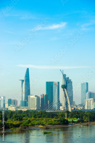 Aerial view of center Ho Chi Minh City, Vietnam with Bitexco Financial tower, Thu Thiem 2 bridge, buildings, energy power infrastructure. View from the Saigon river.