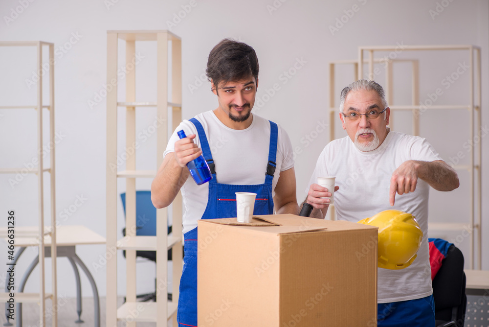 Two male professional movers drinking alcohol during break Two male professional movers drinking alcohol during break