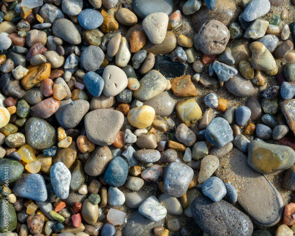Pebbles of different colors, shapes, and textures on a beach