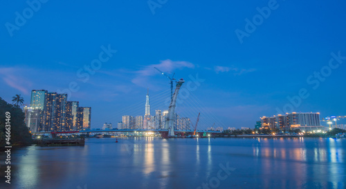 skyline with landmark 81 skyscraper, a new cable-stayed bridge is building connecting Thu Thiem peninsula and District 1 across the Saigon River.