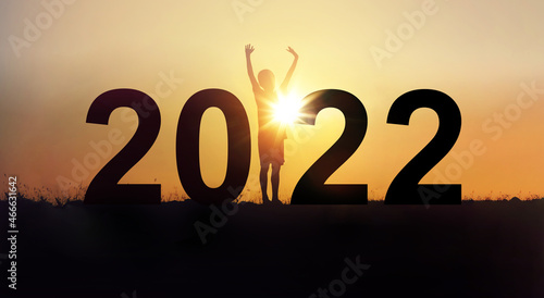 2022 happy new years christmas eve, Silhouette a boy is standing arms raised up with happiness in outdoor.