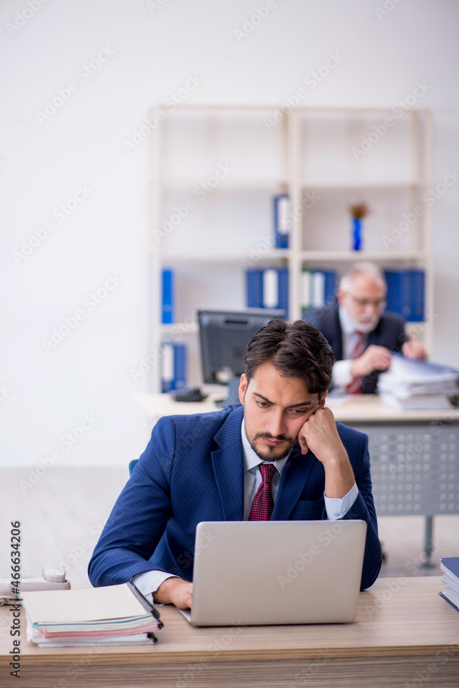 Two male colleagues working in the office Two male colleagues working in the office