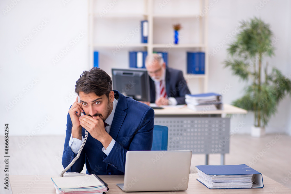 Two male colleagues working in the office