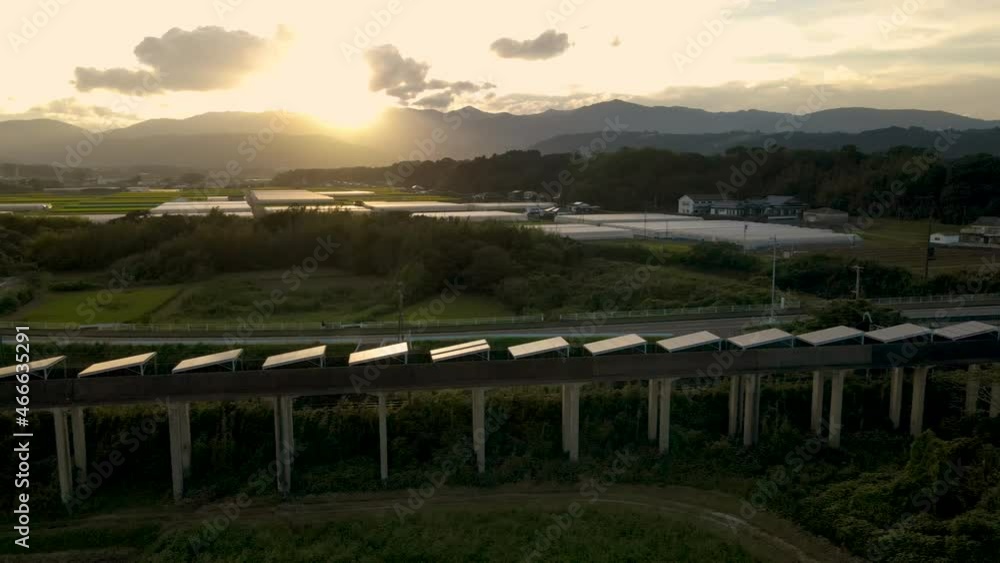 Panning Aerial Of Solar Panels On An Abandoned Monorail Track In Japan At Sunset Panning Aerial Of Solar Panels On An Abandoned Monorail Track In Japan At Sunset